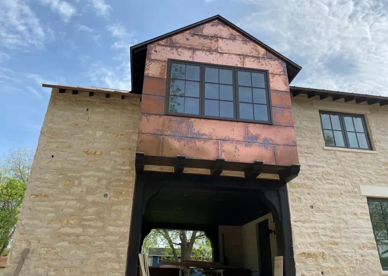 Copper metal panel facade on a stone building for Roof Repair in Mahwah